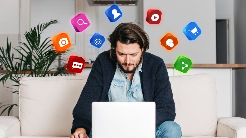 Person using laptop with floating social media icons, illustrating digital marketing challenges in FMCG branding.